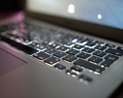 CloseUpOfLaptopKeyboardColorfulNeonIlluminationBacklitKeyboard