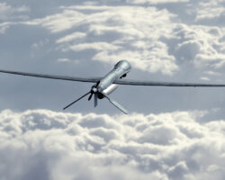 UnmannedMilitaryDroneFlyingInTheSkyAboveTheClouds