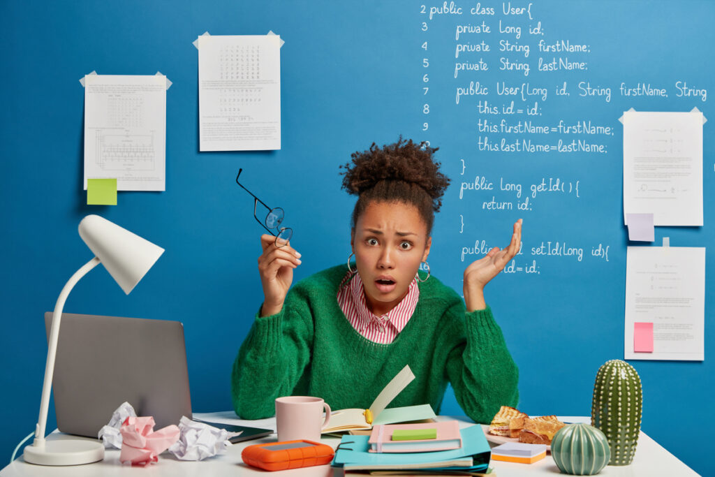 Puzzled indignant office worker feels confused with operational software problems looks in panic afraids of data loss makes notes in notepad raises both hands holds spectalces gets error message - tstpp Озадаченный офисный работник