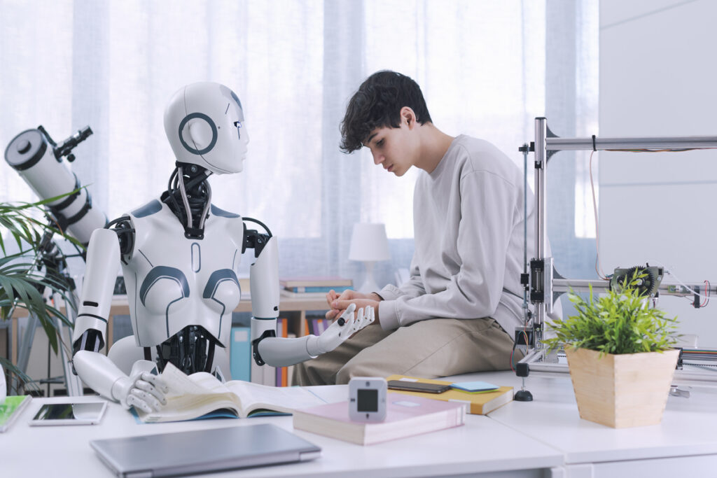 Подросток и робот разговаривают за столом