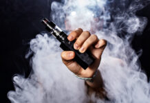 Girl soars on a black background vape