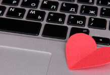 Red heart on computer keyboard close up