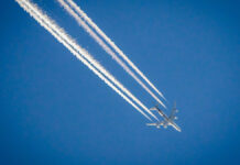 AirplaneInBlueSkyWithPlaneTrails