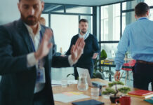 SadCaucasianBusinessmanFailedAtPublicPresentationConferenceDispleasedBusiness