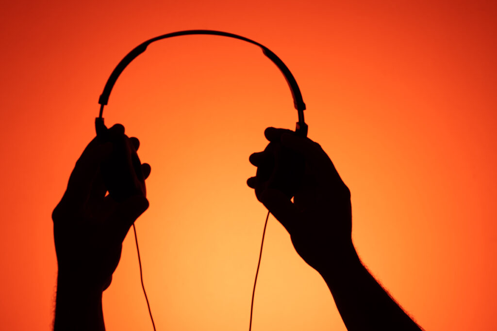 Руки держат наушники