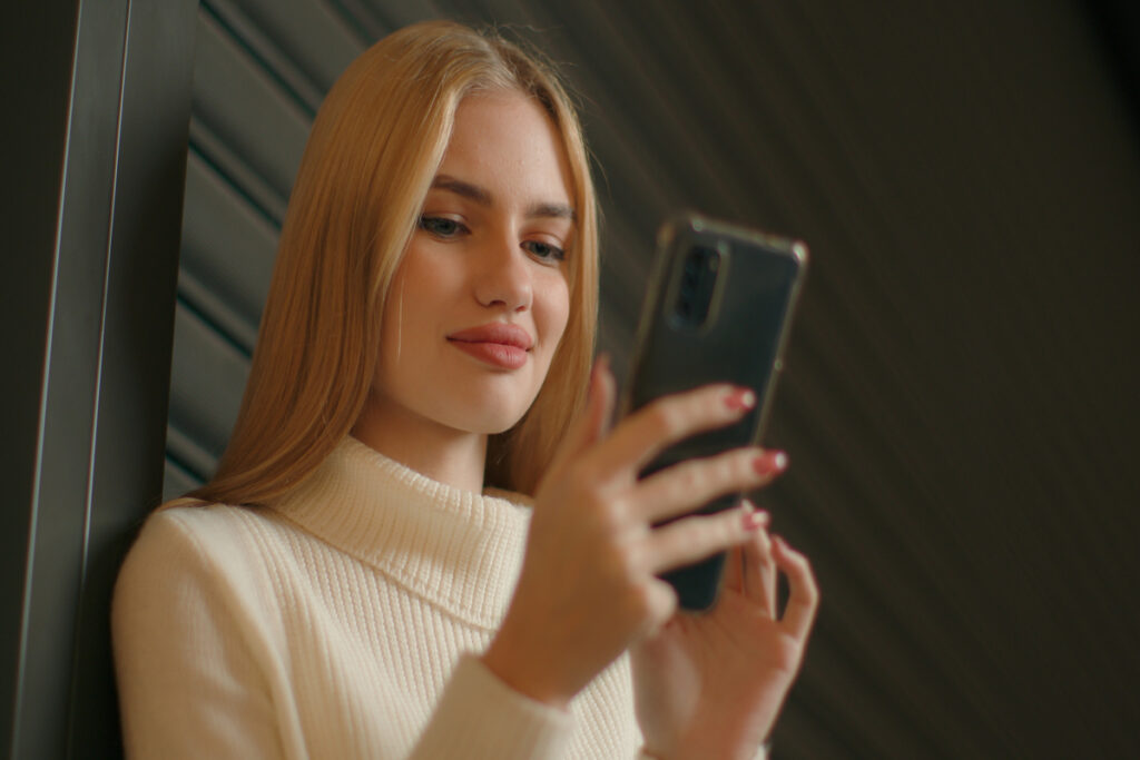 Женщина смотрит в смартфон