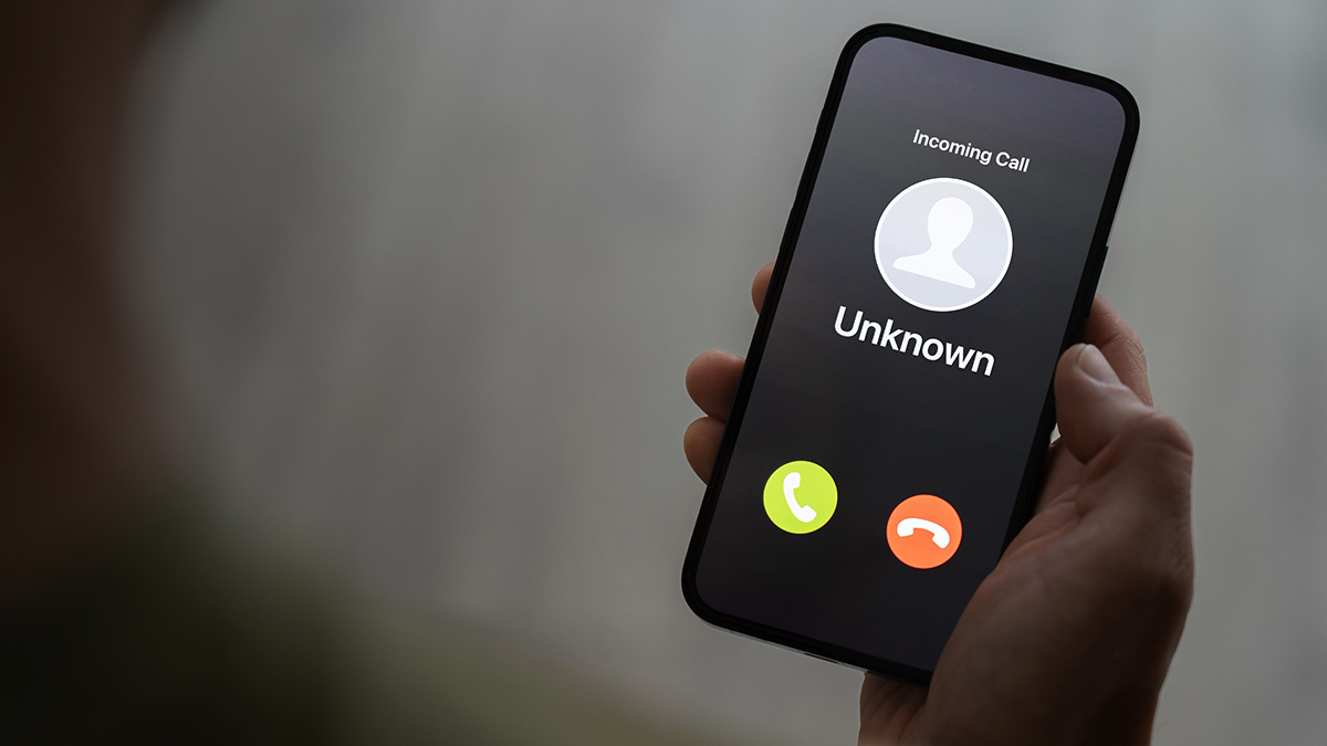Scam,Call,Concept,,Person,Holding,Ringing,Phone,With,Unknown,Caller,