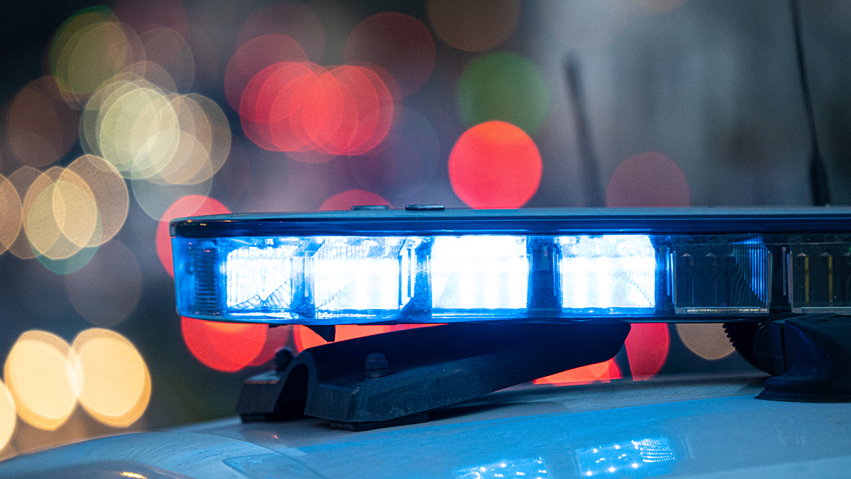 Blue,Lights,On,The,Roof,Of,A,Police,Car,With