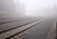 SeveralTrainRailsEndingInFog