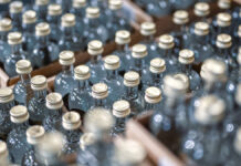 GlassBottlesOfVodkaClosedWithGoldenCapsInWorkshop