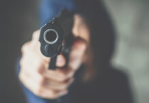 CroppedShotOfFemaleCriminalorThiefWearingHoodAnd