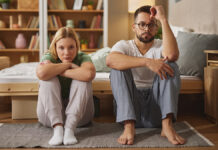 UpsetCoupleIgnoringEachOtherAfterFightInBedroom