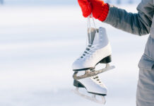 Российские спортсмены готовятся к Олимпиаде 2026 через проверку ISU Young woman showing ice skates for winter