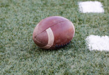 Третий сезон корпоративного турнира по тэг-регби ЦСКА стартовал в Москве AmericanFootballBallOnTheGrassFieldOfTheStadium