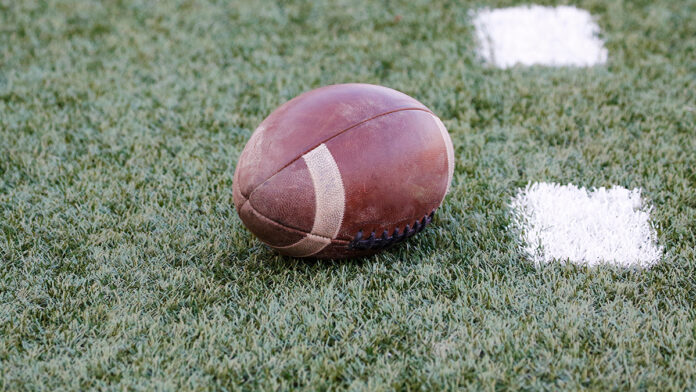 AmericanFootballBallOnTheGrassFieldOfTheStadium