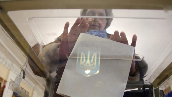 A woman casts her ballot at a polling station during a presidential election in Kiev