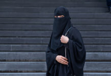 ArabMuslimWomanWearingABlackNiqabInFrontOf