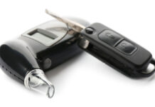 ModernBreathalyzerAndCarKeyOnWhiteBackground