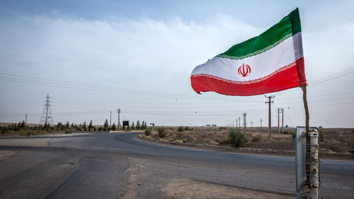 IranianFlagOnTheRoadNextToMaranjabDesertIn