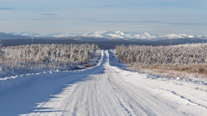 WinterRoadGoingDownTheSlopeOfTheHillAgainst