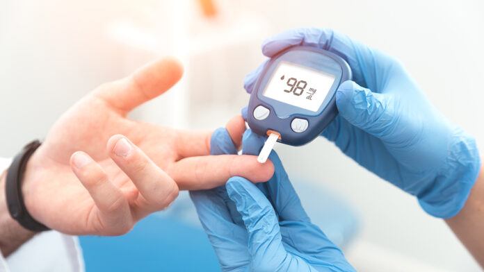 DoctorCheckingBloodSugarLevelWithGlucometerTreatmentOfDiabetes