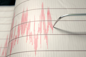 A,Closeup,Of,A,Seismograph,Machine,Needle,Drawing,A,Red