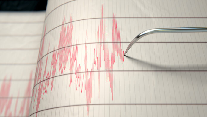 A,Closeup,Of,A,Seismograph,Machine,Needle,Drawing,A,Red