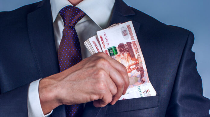 Bearded man removes rubles in his suit pocket