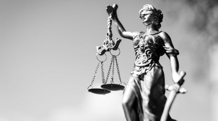 Picture of themis, femida or justice goddess on bright sky copy space background