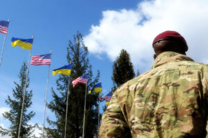American Soldiers and flags of the Ukraine and USA at background