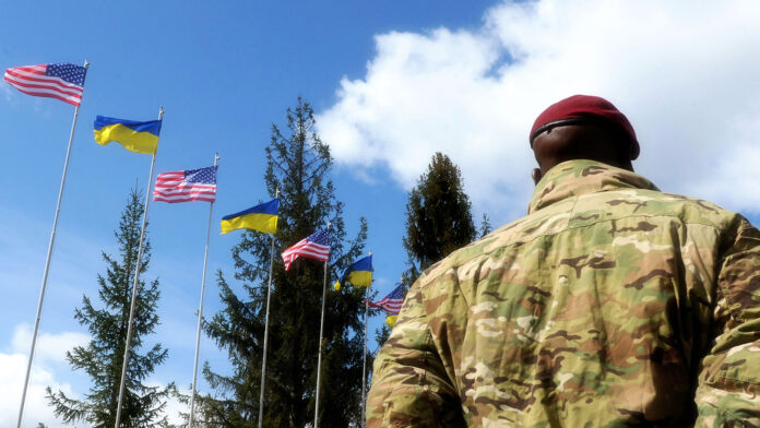 American Soldiers and flags of the Ukraine and USA at background