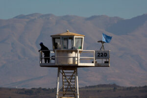 United Nations peacekeeping soldier stands on an observation tower near the Quneitra border crossing, in the Israeli-occupied Golan Heights