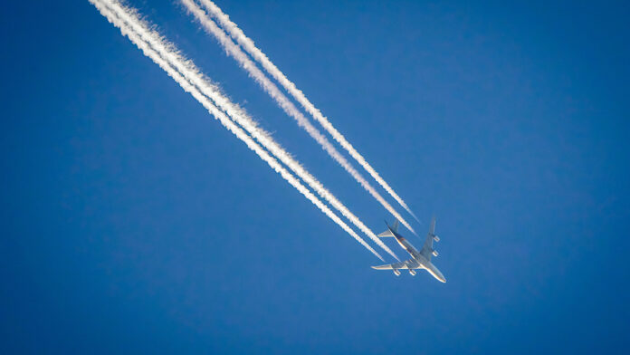 Airplane,In,Blue,Sky,With,Plane,Trails