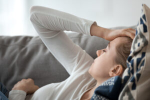 Upset,Depressed,Young,Woman,Lying,On,Couch,Feeling,Strong,Headache