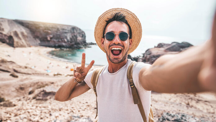 Young,Man,With,Backpack,Taking,Selfie,Portrait,On,A,Mountain
