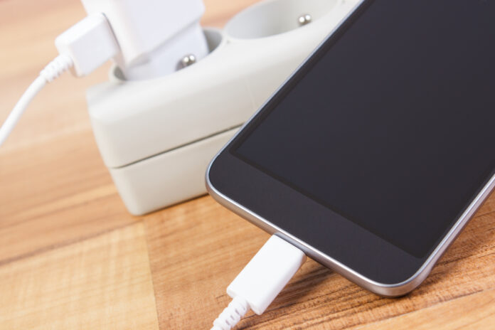 Smartphone with connected plug of charger, telephone charging Смартфон на зарядке