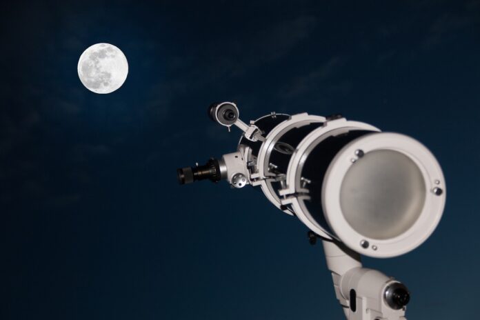 Astronomical telescope over dark sky with the moon Телескоп и луна