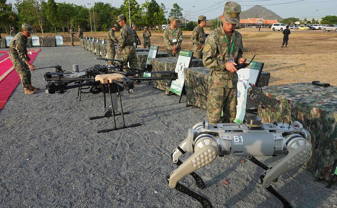 Военнослужащий китайской армии испытывает пулемет, установленный на роботе на военных учения Золотой дракон Камбоджи и Китая, 2024 год (Heng Sinith / AP / ТАСС)