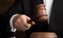 JusticeAndLawConceptMaleJudgeInACourtroomStriking