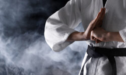 В Москве пройдут Международные соревнования по кекусинкан KarateFighterInSmokeOnBlackBackgroundCloseupBannerDesign