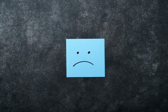 синий стикер с рисунком грустного лица