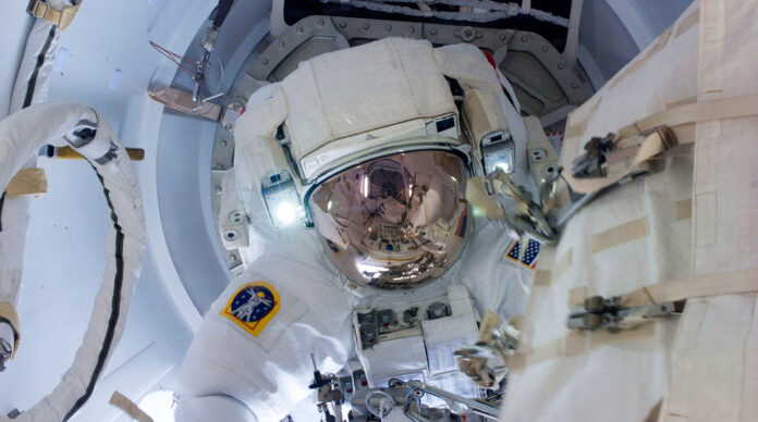 NASA astronaut Greg Chamitoff attired in his Extravehicular Mobility Unit EMU spacesuit is seen at beginning of spacewalk in the ISS