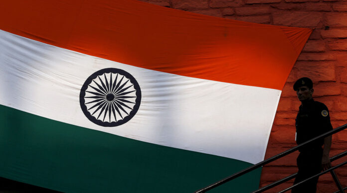 An Indian security commando leaves the historic Red Fort after the full-dress rehearsal for Indias Independence Day celebrations in Delhi