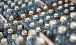 GlassBottlesOfVodkaClosedWithGoldenCapsInWorkshop