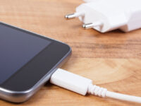 Mobile phone with connected plug of charger, smartphone charging