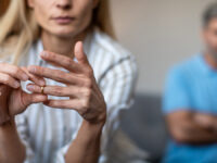 Unhappy,Middle,Aged,European,Lady,Takes,Off,Ring,,Ignoring,Man