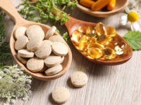 Different,Pills,,Herbs,And,Flowers,On,Wooden,Table,,Closeup.,Dietary