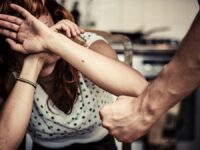 Woman,Covering,Her,Face,In,Fear,Of,Domestic,Violence
