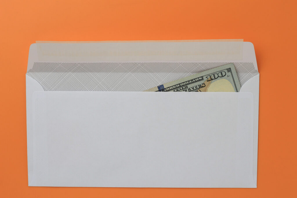 Белый новый почтовый конверт с долларами внутри
