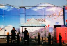 На границе Китая и Казахстана зафиксирована сейсмическая активность FILE PHOTO FILE PHOTO Security guards stand at the gates of what is officially known as a vocational skills education centre in Huocheng County